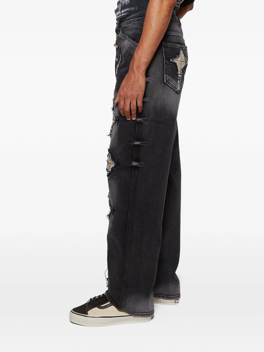 black jeans worn by a person, showing the jeans fit