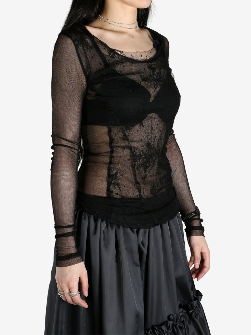 Black t-shirts worn by a person, showing the t-shirts fit