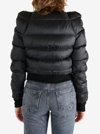 Black jacket worn by a person, showing the jacket fit