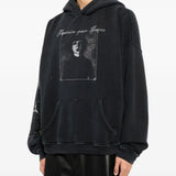 Black hoodie worn by a person, showing the hoodie's fit