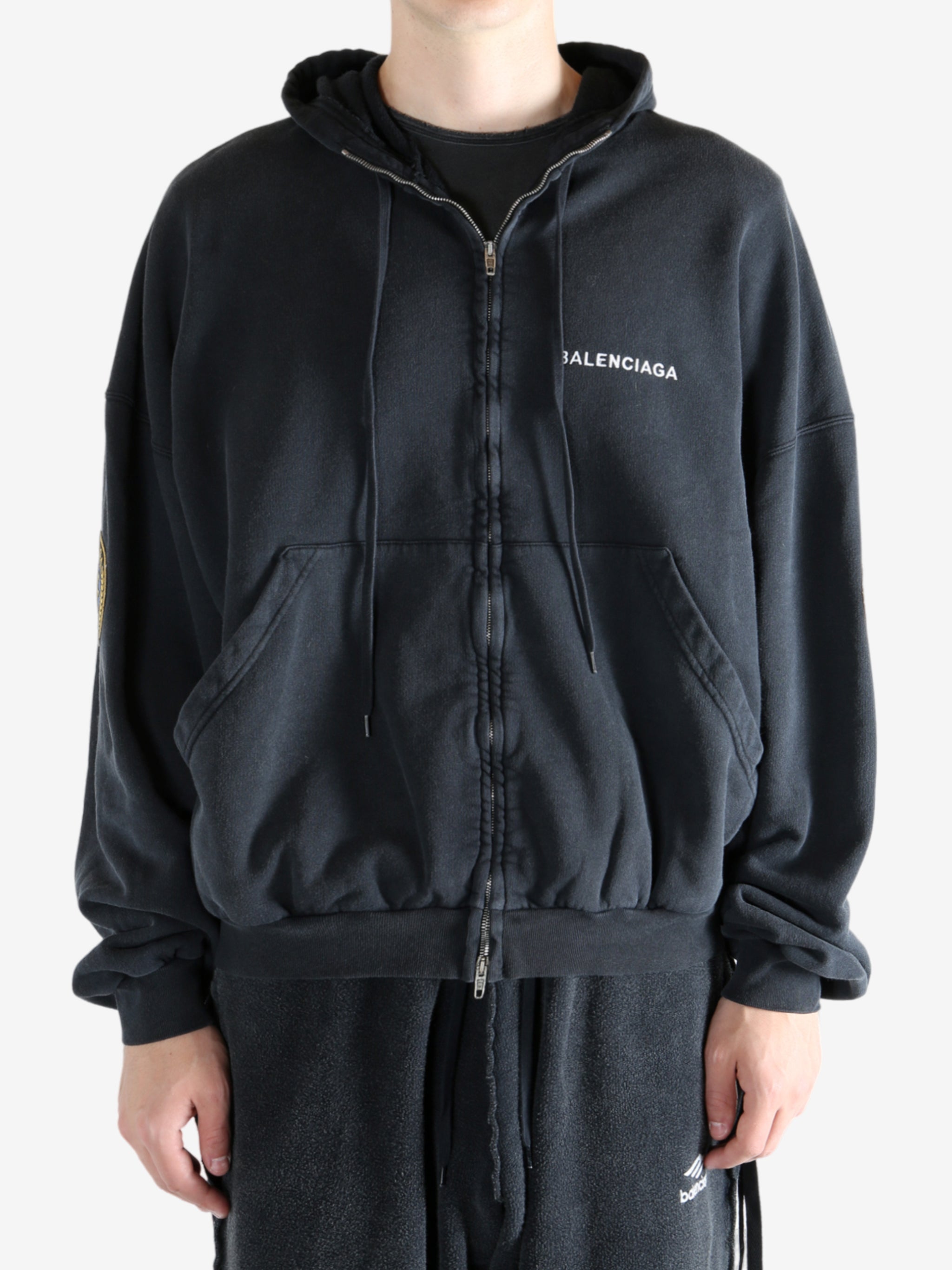 Black hoodie worn by a person, showing the hoodie's fit