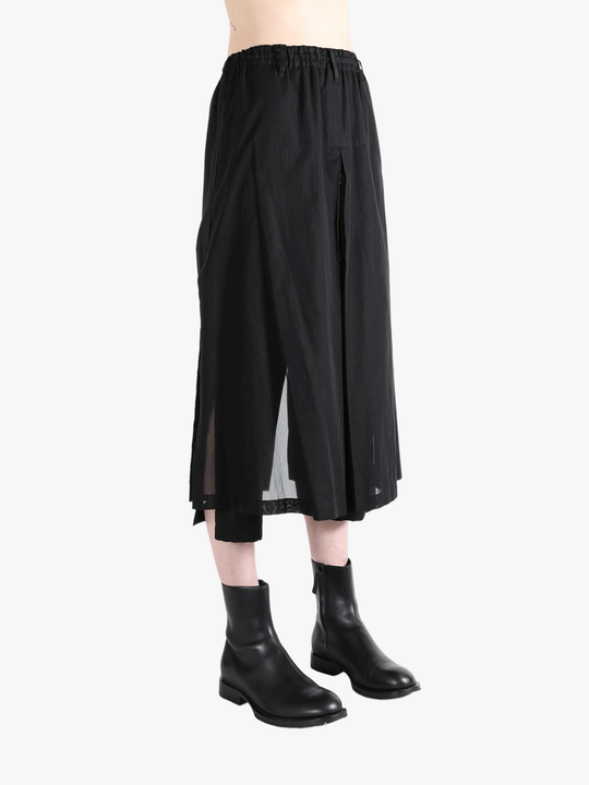 Black pants worn by a person, showing the pants fit