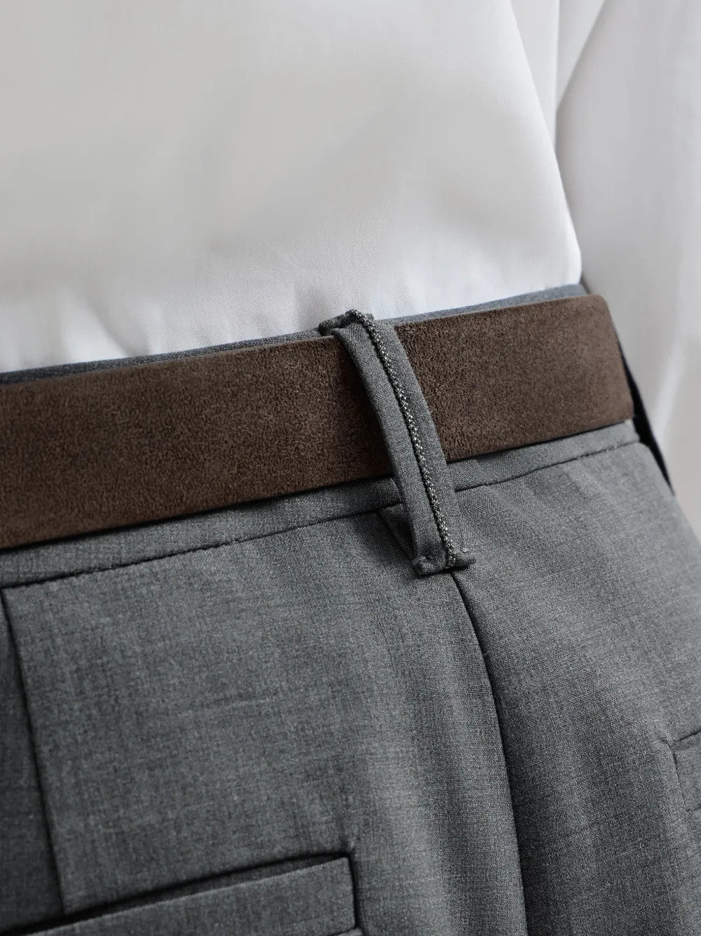 Grey pants worn by a person, showing the pants fit