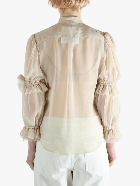 Tan t-shirt worn by a person, showing the t-shirt's fit
