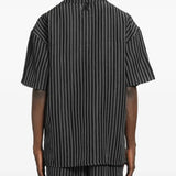 Black shirt worn by a person, showing the shirt's fit