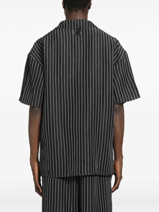 Black shirt worn by a person, showing the shirt's fit