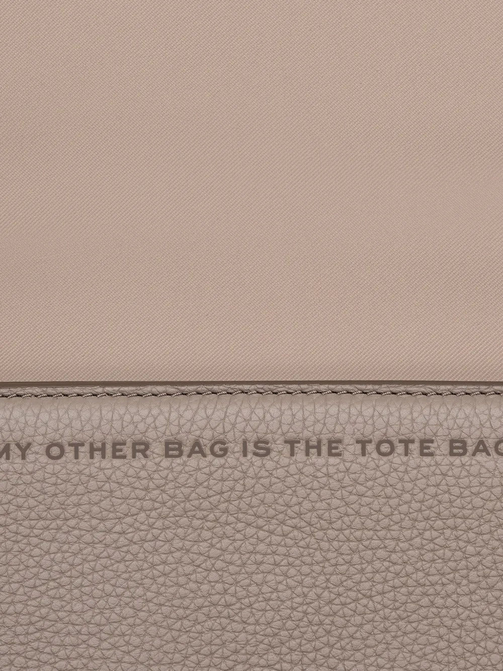 Close up of tan bags, showing texture of the cow leather fabric