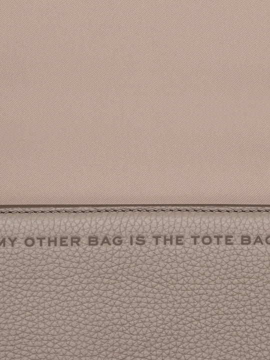 Close up of tan bags, showing texture of the cow leather fabric