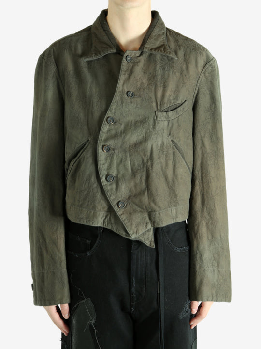 Green jacket worn by a person, showing the jacket's fit