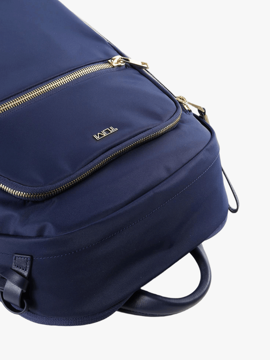 Close up of navy backpack, showing texture of the nylon fabric