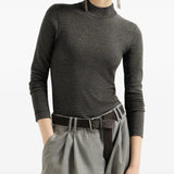 Grey knitwear worn by a person, showing the knitwear fit