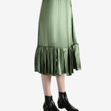 Green skirt worn by a person, showing the  skirt's fit