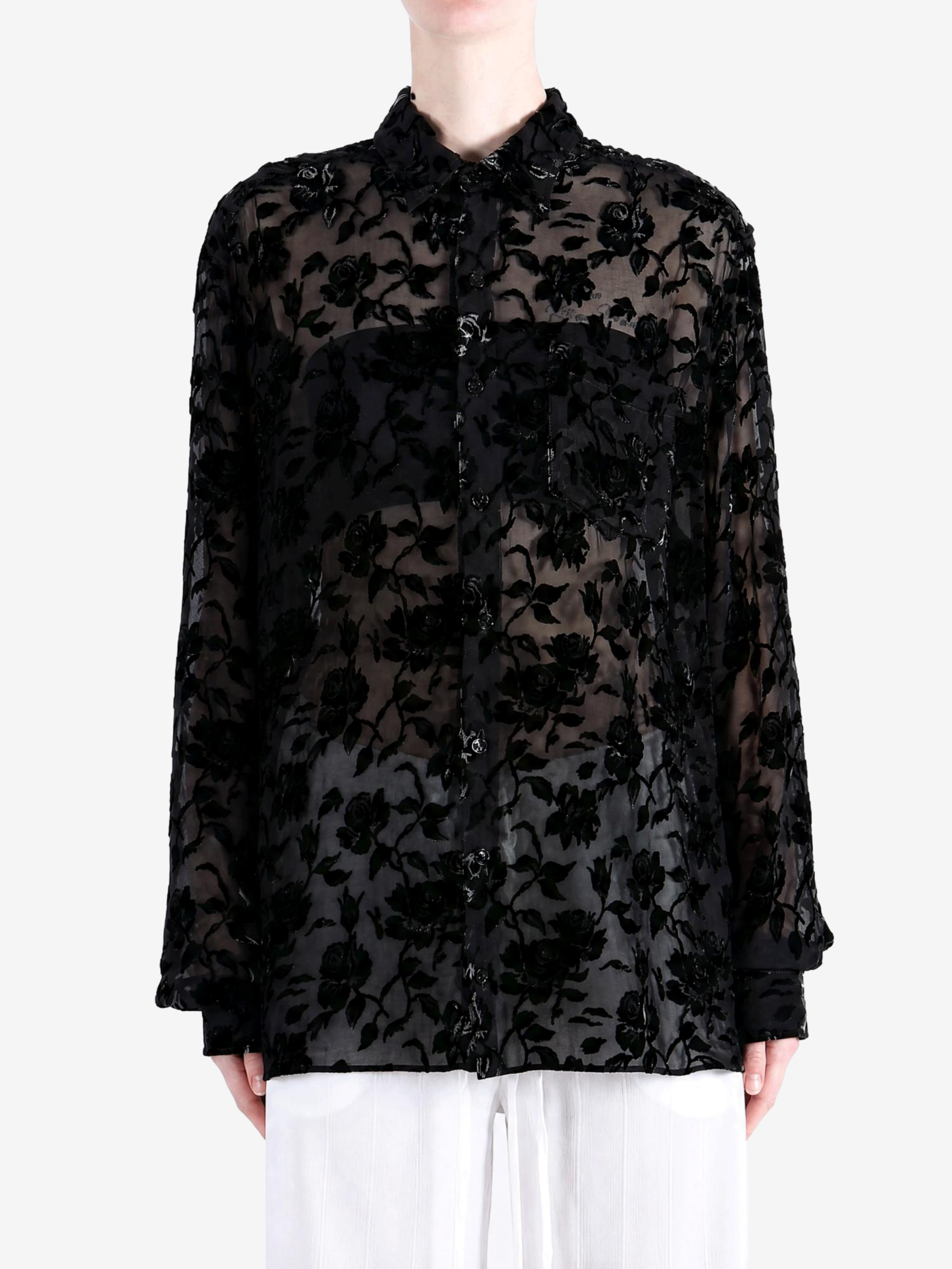 Black shirt worn by a person, showing the shirt fit