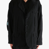 Black jacket worn by a person, showing the  jacket's fit