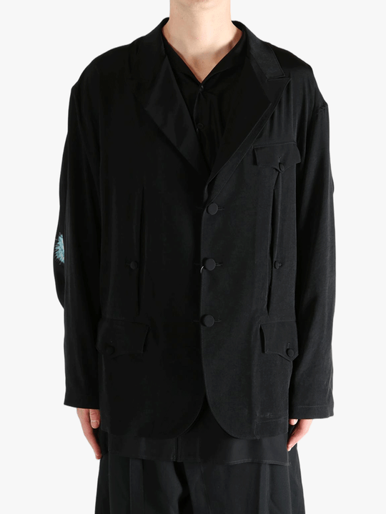 Black jacket worn by a person, showing the  jacket's fit