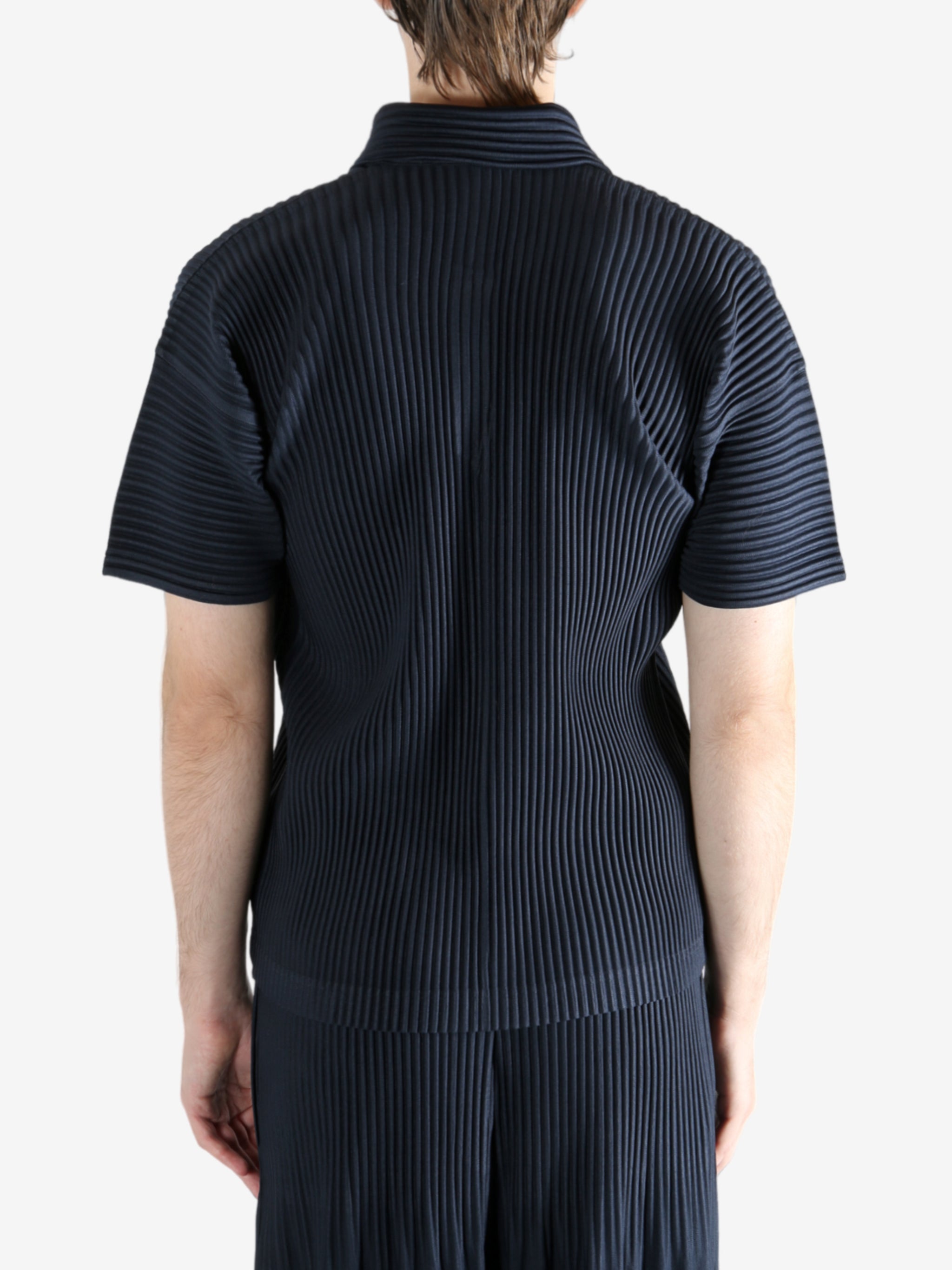 Navy shirt worn by a person, showing the shirt's fit