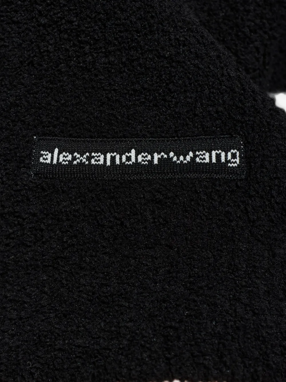 Close up of black hoodie, showing texture of the Polyester fabric