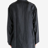 Black shirt,worn by a person, showing the shirt's fit