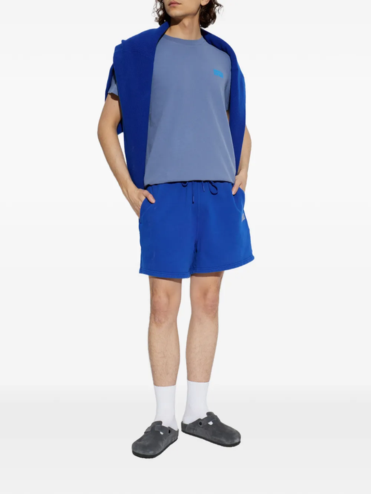 Black clog shoe worn by a person, showing the shoes fit