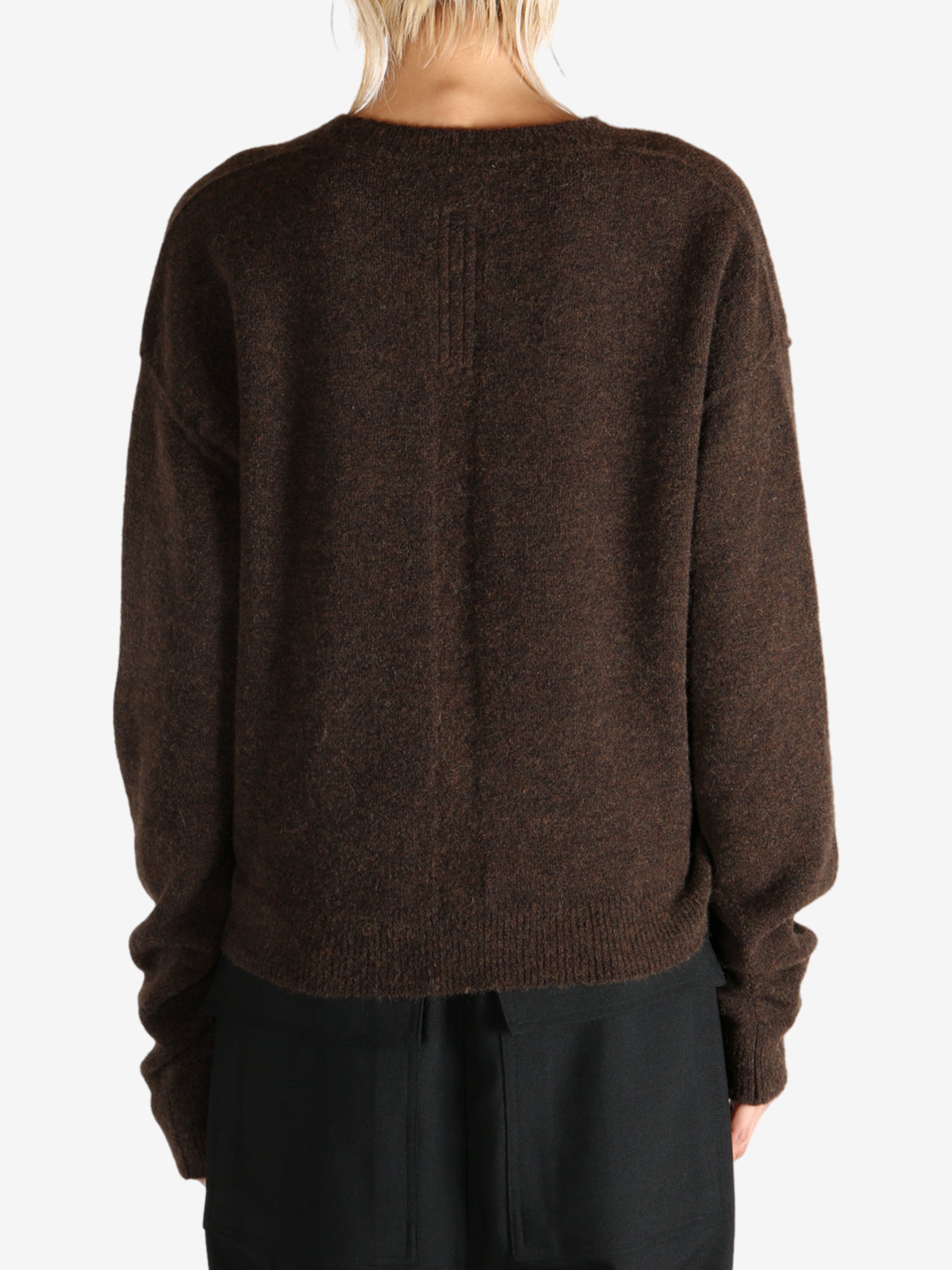 Brown knitwear worn by a person, showing the knitwear's fit