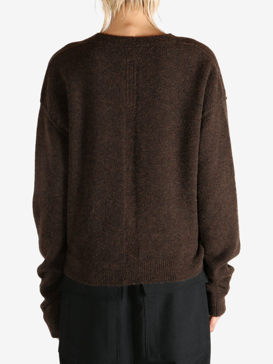 Brown knitwear worn by a person, showing the knitwear's fit