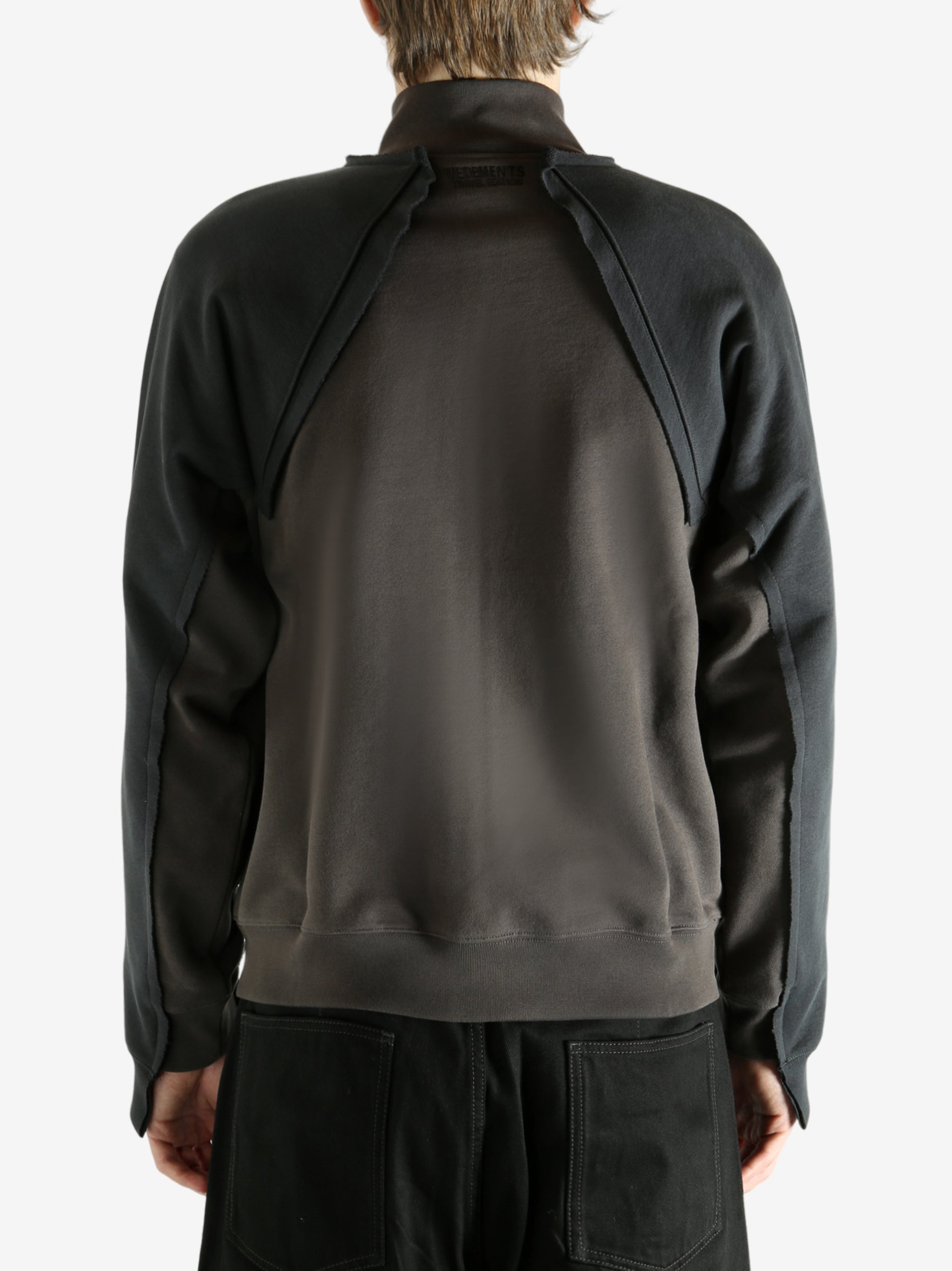 Brown jacket worn by a person, showing the jacket's fit