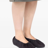 black sneakers worn by a person, showing the sneakers fit