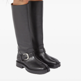 black boots worn by a person, showing the boots fit