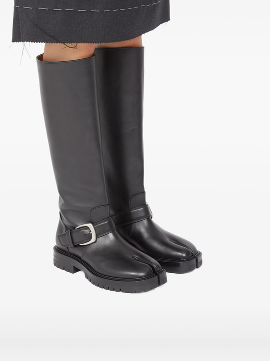 black boots worn by a person, showing the boots fit