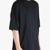 Black t-shirt worn by a person, showing the t-shirt's fit