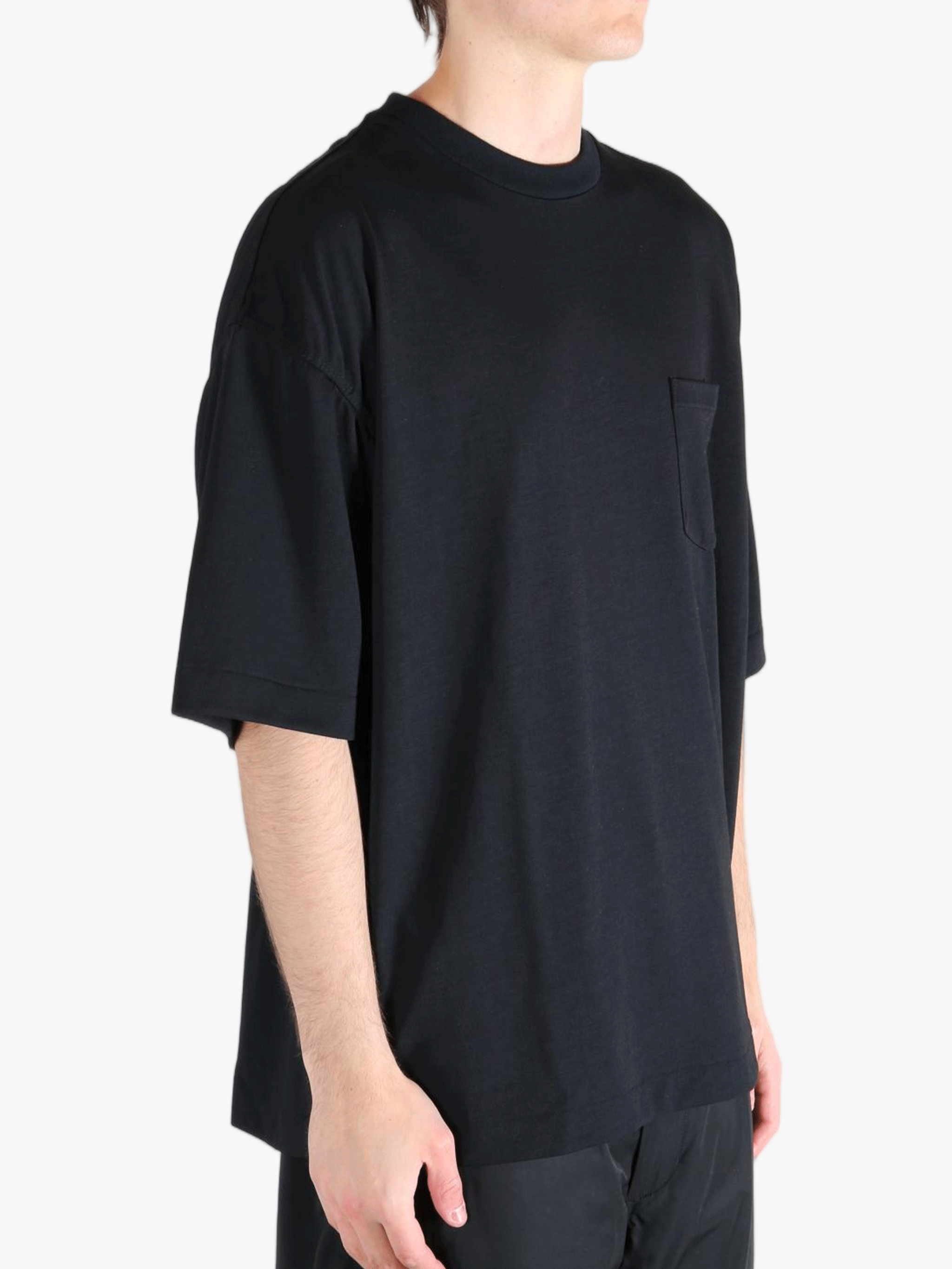 Black t-shirt worn by a person, showing the t-shirt's fit