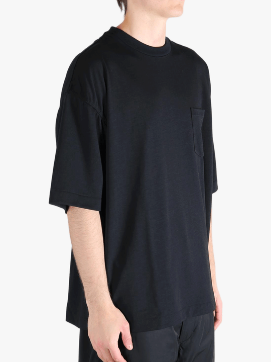 Black t-shirt worn by a person, showing the t-shirt's fit