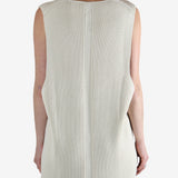 White top worn by a person, showing the top's fit