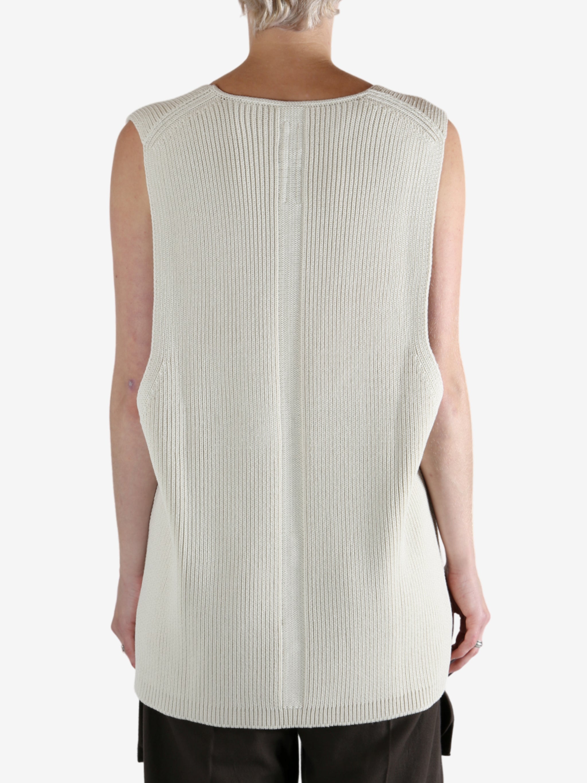 White top worn by a person, showing the top's fit