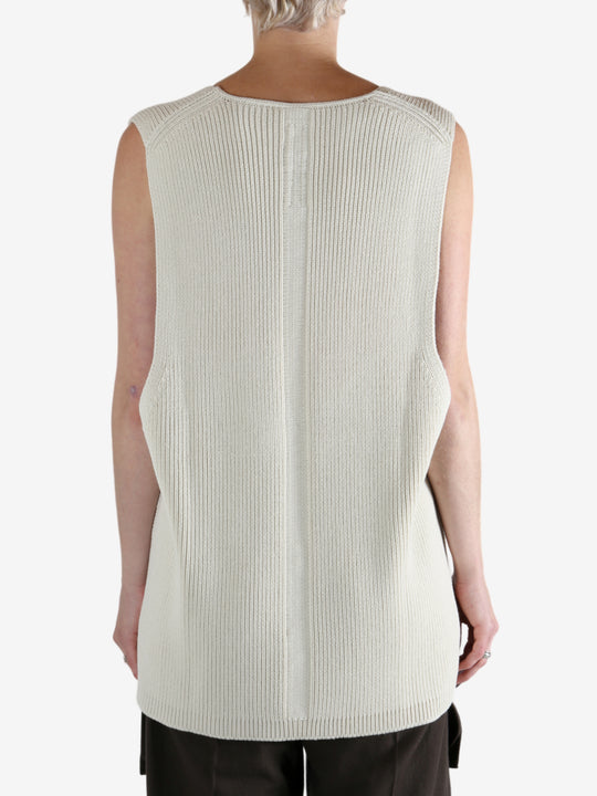 White top worn by a person, showing the top's fit