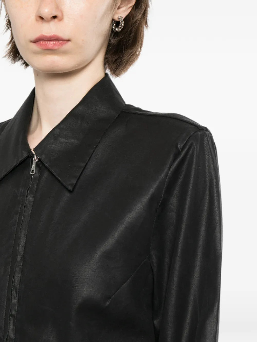 Black shirt worn by a person, showing the shirt fit