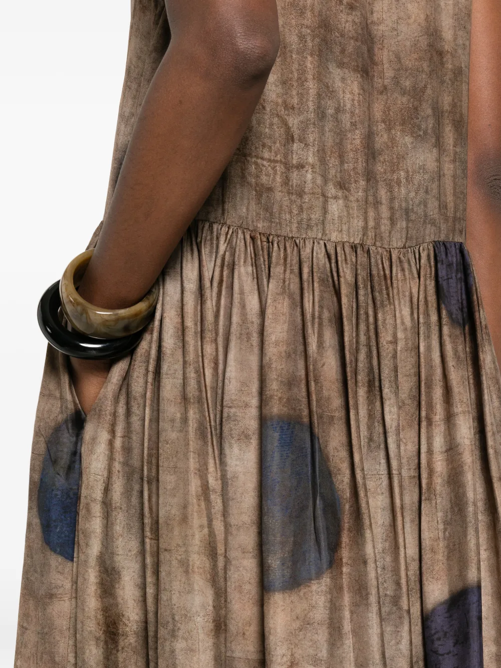 Close up of brown dress, showing texture of the viscose fabric