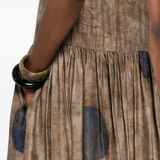 Close up of brown dress, showing texture of the viscose fabric