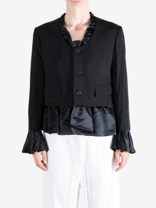 Black jacket worn by a person, showing the jacket fit