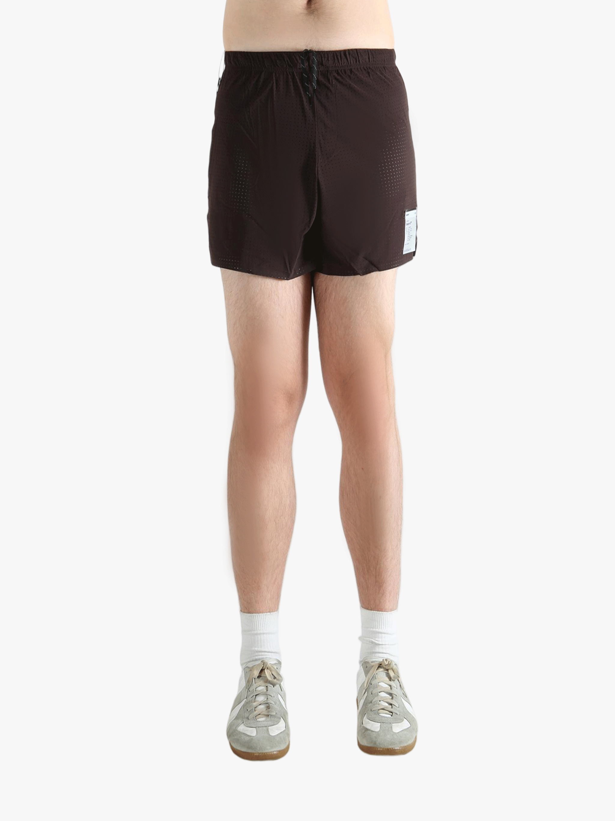 Brown shorts worn by a person, showing the shorts fit