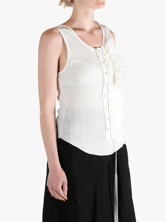 White top worn by a person, showing the top's fit