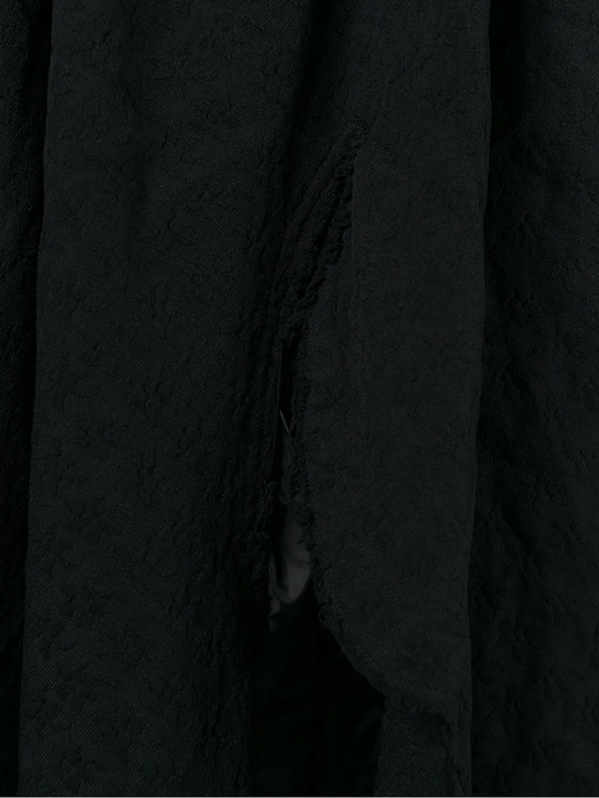 Close up of black skirt , showing texture of the polyester fabric