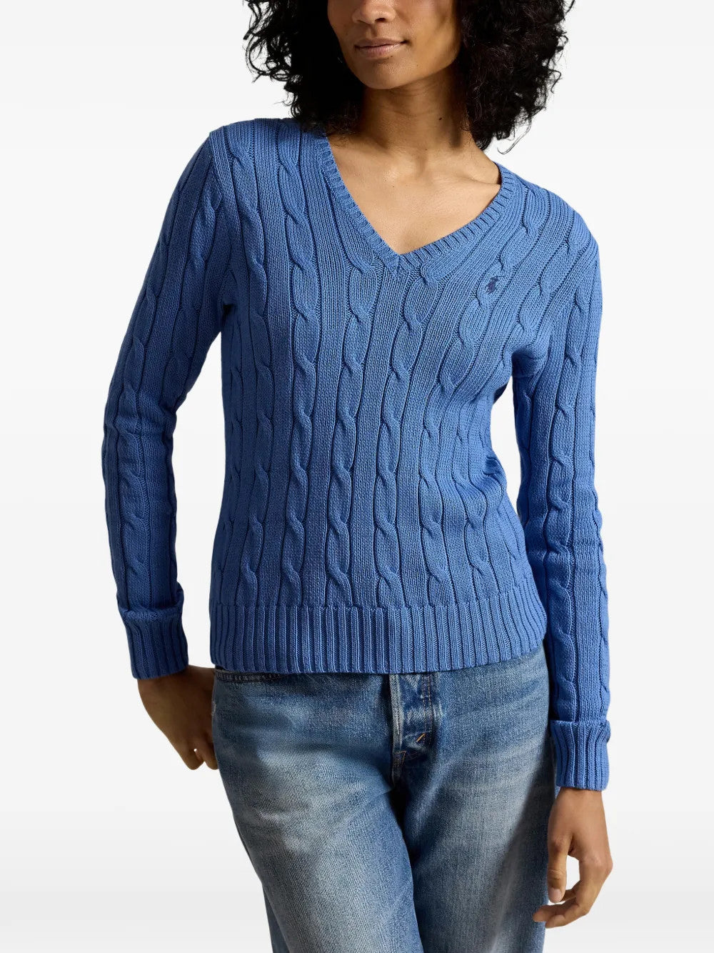 Blue knitwear worn by a person, showing the knitwear fit