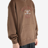 Brown hoodie worn by a person, showing the hoodie's fit