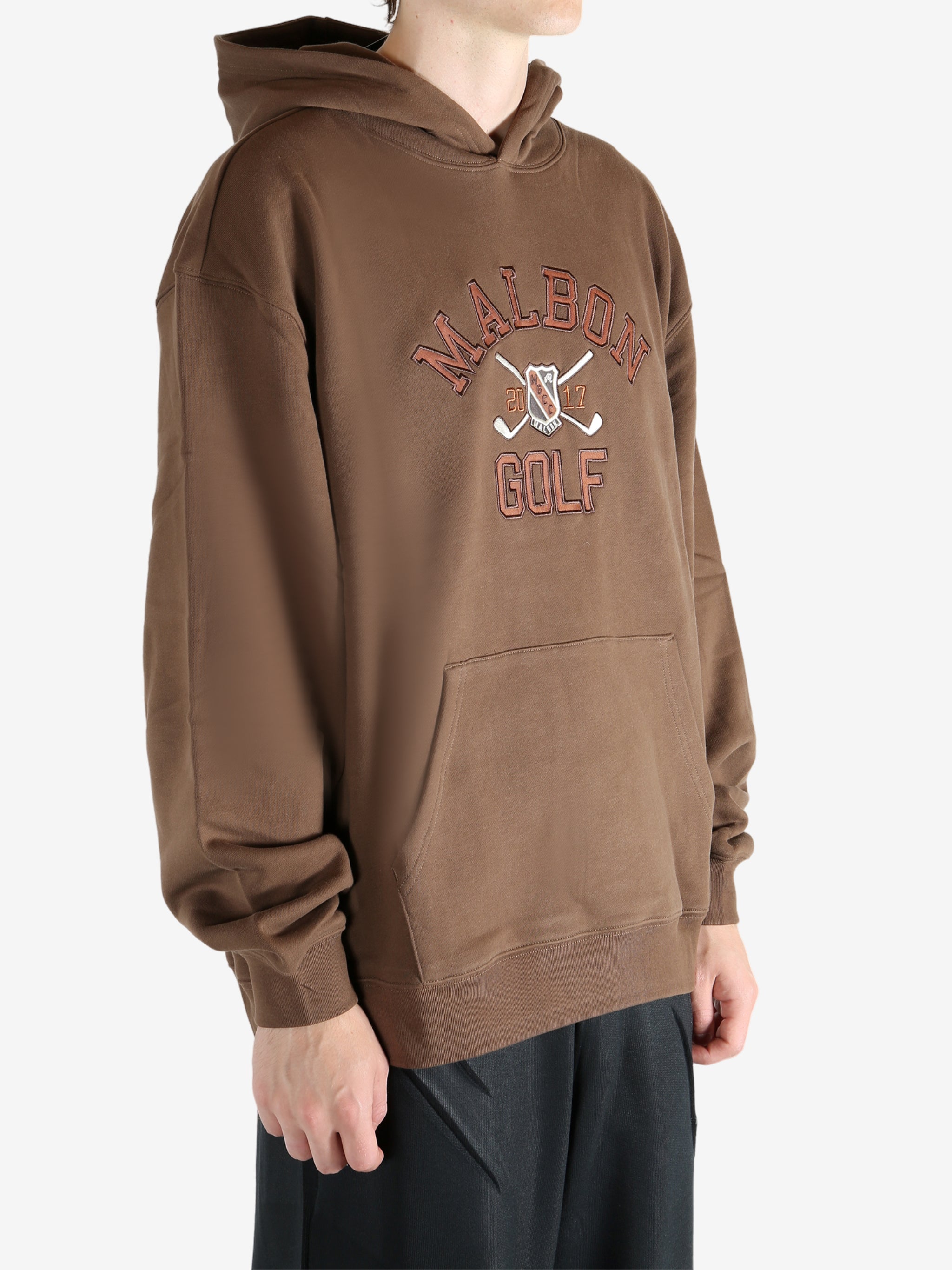 Brown hoodie worn by a person, showing the hoodie's fit