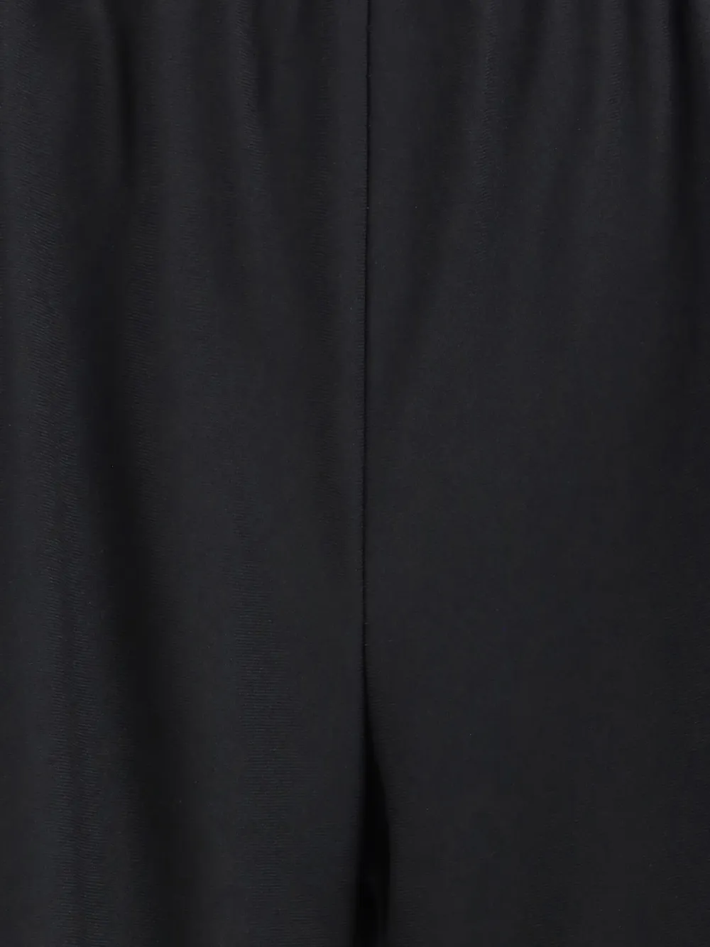 Close up of black pants, showing texture of the virgin wool fabric