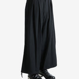 Black pants worn by a person, showing the pants fit