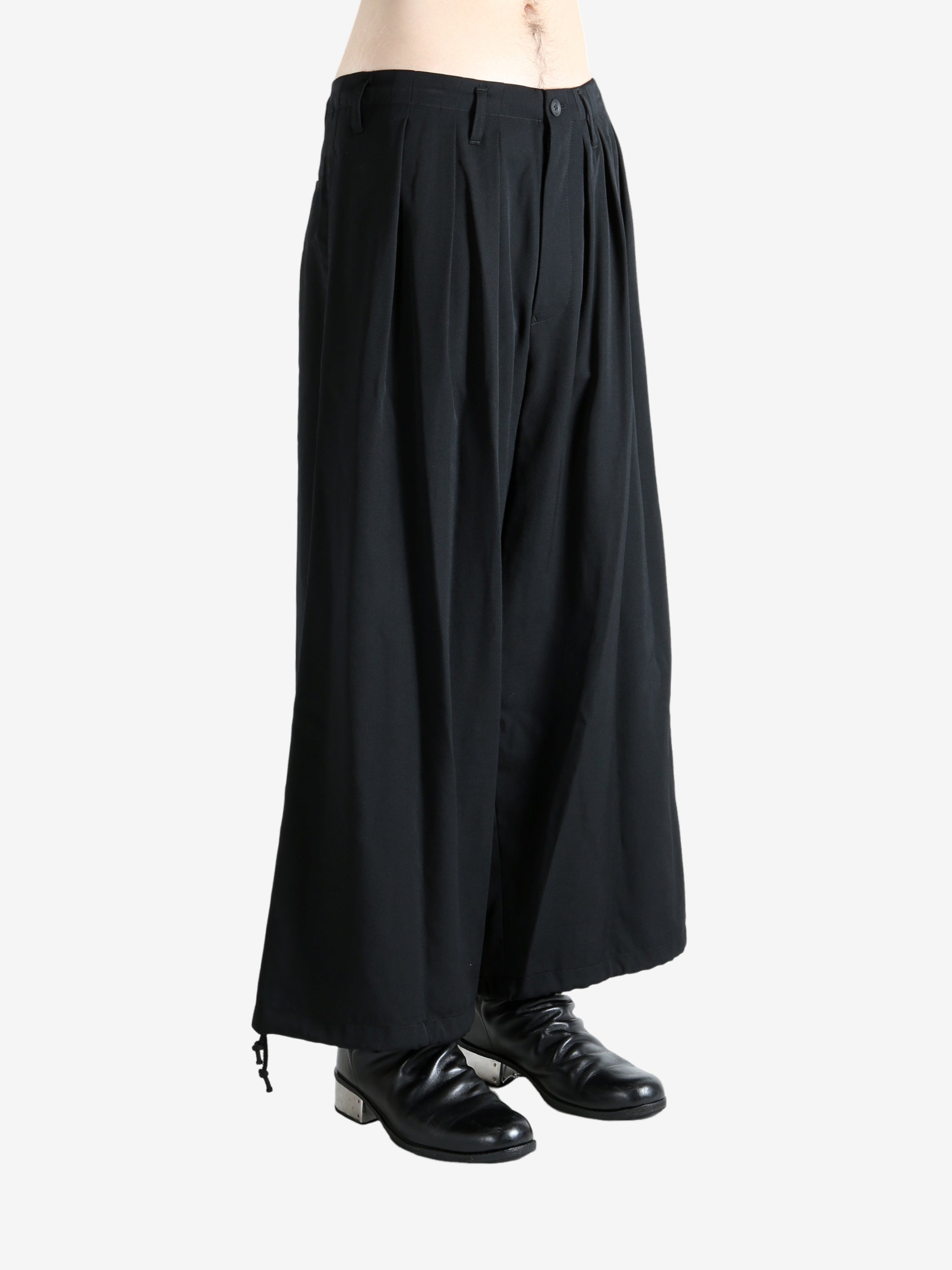 Black pants worn by a person, showing the pants fit