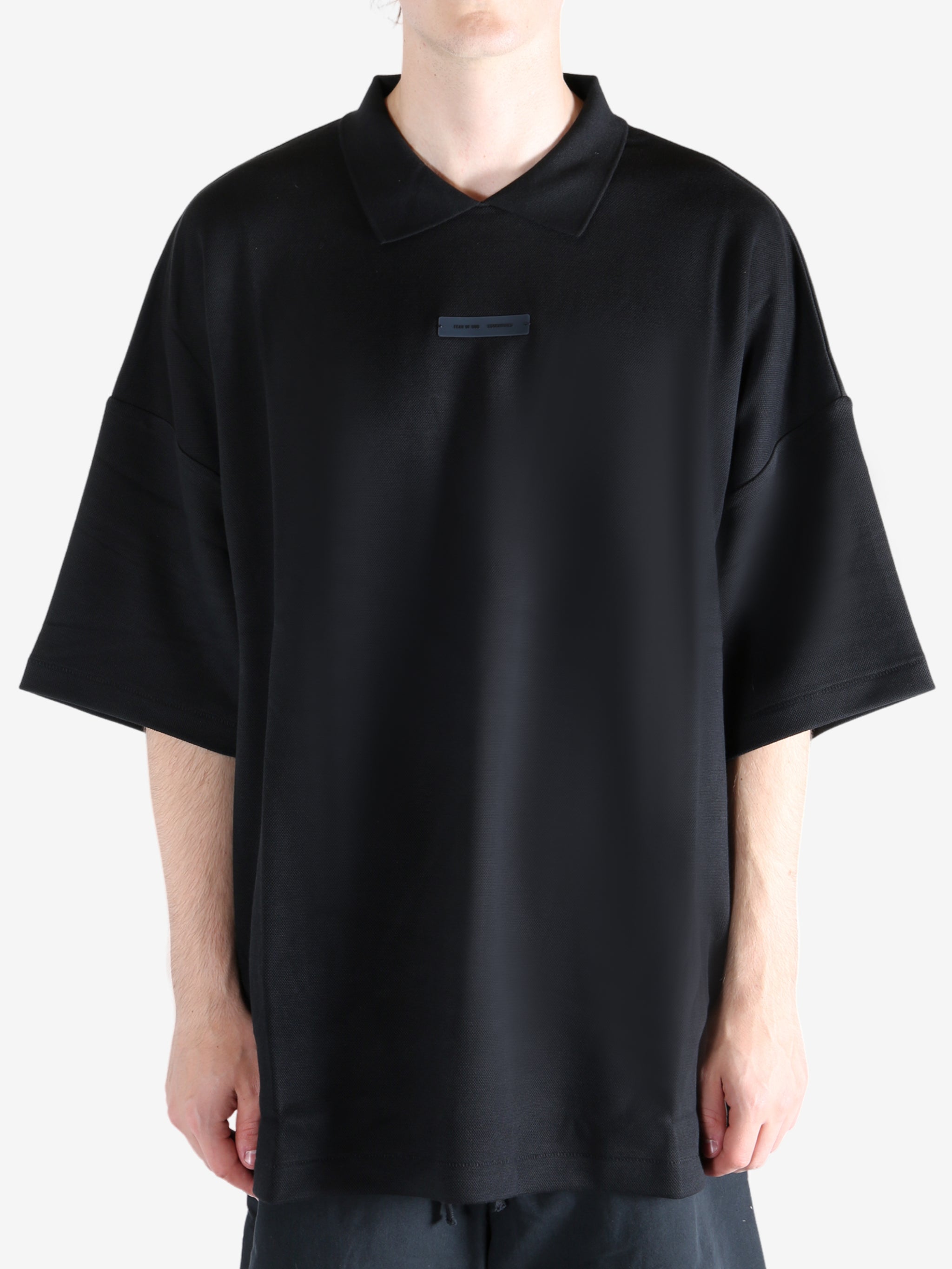 Black t-shirt worn by a person, showing the t-shirt's fit