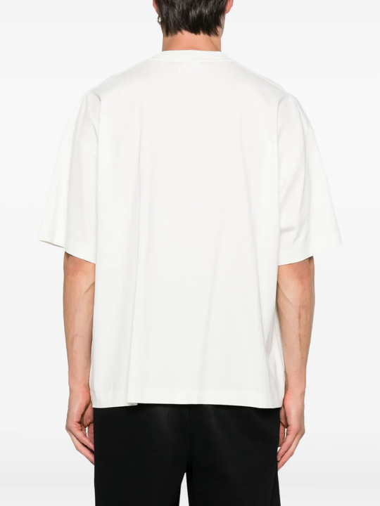 White t-shirt worn by a person, showing the shirt's fit